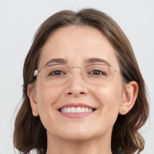 Joyful white adult female with medium  brown hair and grey eyes