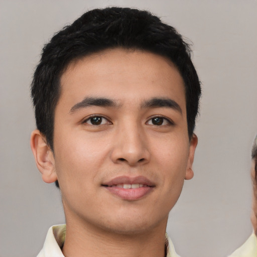 Joyful latino young-adult male with short  brown hair and brown eyes