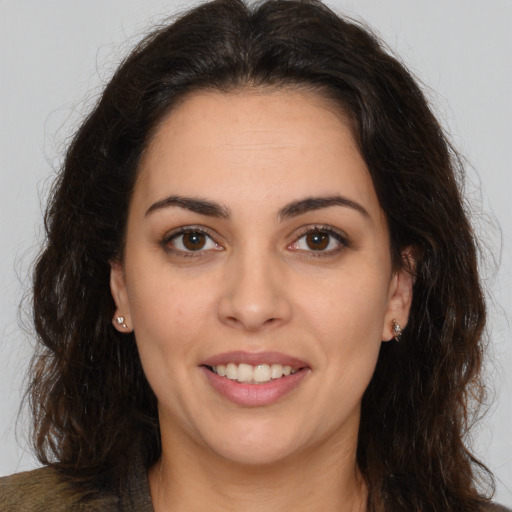 Joyful white young-adult female with long  brown hair and brown eyes