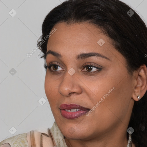 Joyful latino young-adult female with medium  brown hair and brown eyes