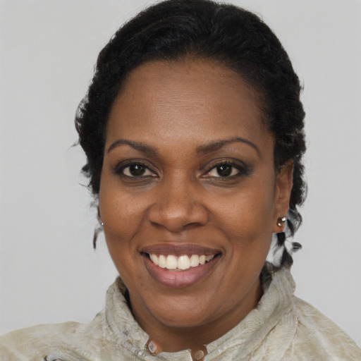 Joyful black adult female with medium  brown hair and brown eyes