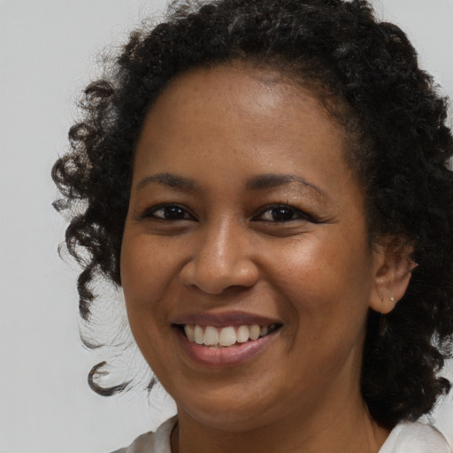 Joyful black young-adult female with medium  brown hair and brown eyes