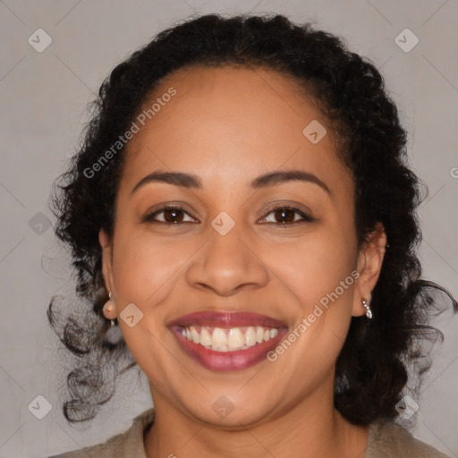 Joyful black adult female with long  brown hair and brown eyes