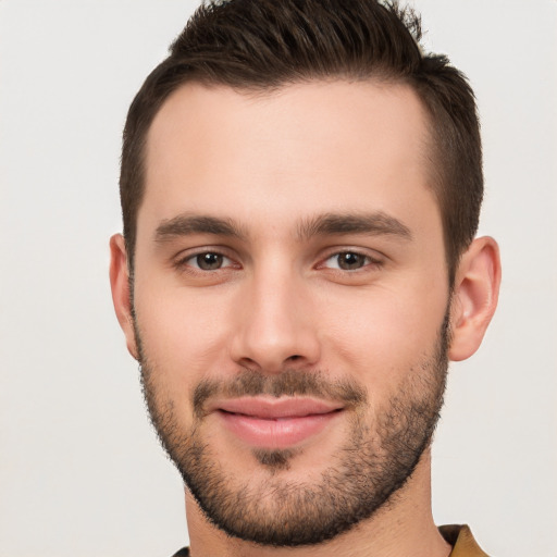 Joyful white young-adult male with short  brown hair and brown eyes