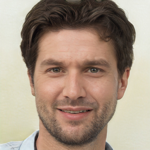 Joyful white adult male with short  brown hair and brown eyes