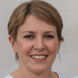 Joyful white adult female with medium  brown hair and grey eyes