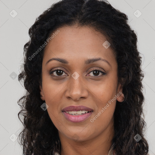 Joyful black young-adult female with long  brown hair and brown eyes