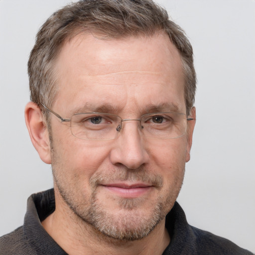 Joyful white adult male with short  brown hair and grey eyes