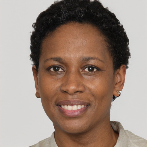 Joyful black adult female with short  black hair and brown eyes