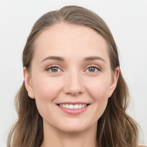 Joyful white young-adult female with long  brown hair and grey eyes