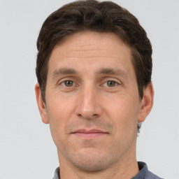 Joyful white adult male with short  brown hair and grey eyes