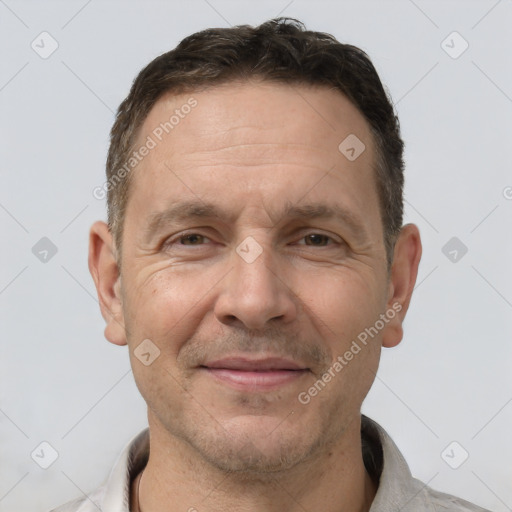 Joyful white adult male with short  brown hair and brown eyes