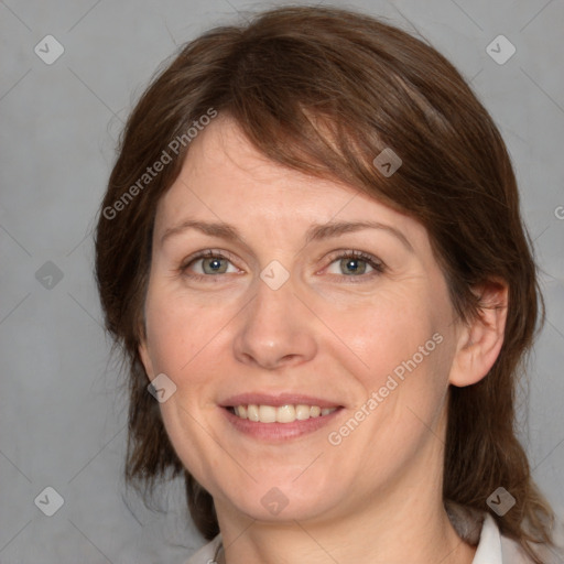 Joyful white adult female with medium  brown hair and grey eyes