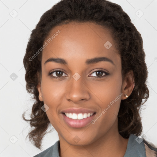 Joyful black young-adult female with long  brown hair and brown eyes