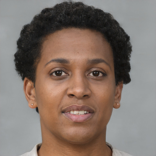 Joyful black young-adult female with short  brown hair and brown eyes