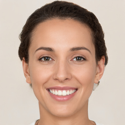 Joyful white young-adult female with short  brown hair and brown eyes