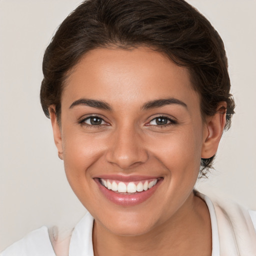 Joyful white young-adult female with medium  brown hair and brown eyes