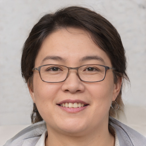 Joyful white adult female with medium  brown hair and brown eyes