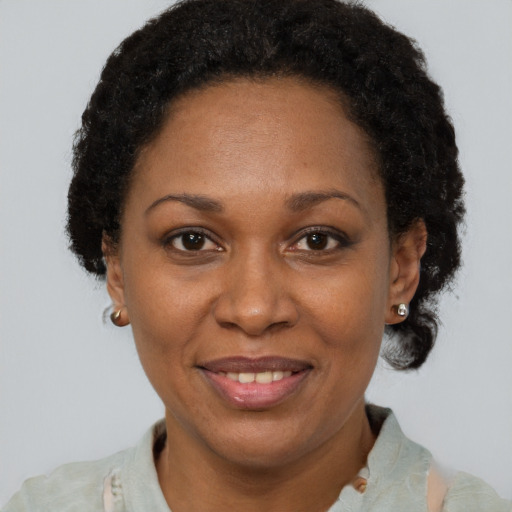 Joyful black adult female with short  brown hair and brown eyes