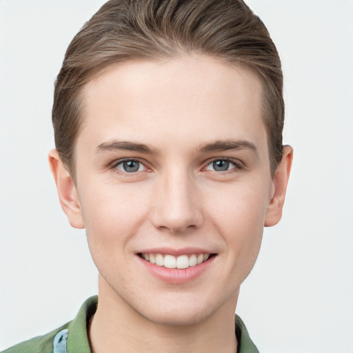 Joyful white young-adult female with short  brown hair and grey eyes