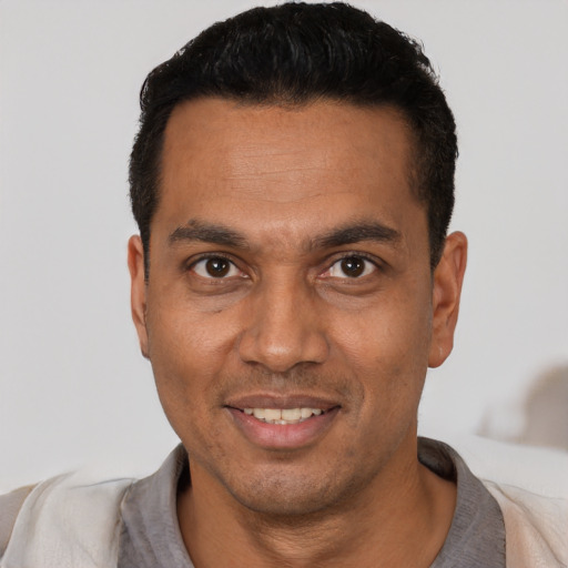 Joyful white young-adult male with short  black hair and brown eyes