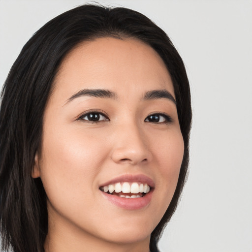 Joyful white young-adult female with long  black hair and brown eyes