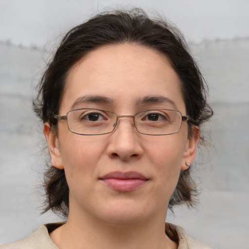 Joyful white adult female with medium  brown hair and brown eyes