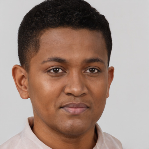 Joyful black young-adult male with short  brown hair and brown eyes
