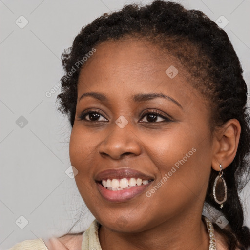 Joyful black young-adult female with medium  brown hair and brown eyes