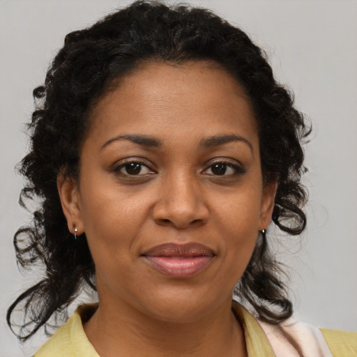 Joyful black adult female with medium  brown hair and brown eyes