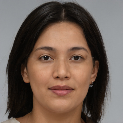 Joyful latino young-adult female with medium  brown hair and brown eyes