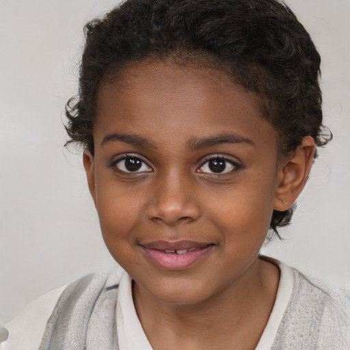 Joyful black child female with short  brown hair and brown eyes