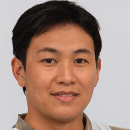 Joyful asian young-adult male with short  brown hair and brown eyes