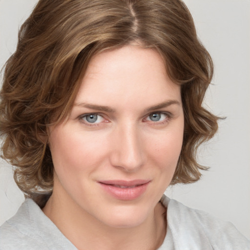 Joyful white young-adult female with medium  brown hair and blue eyes