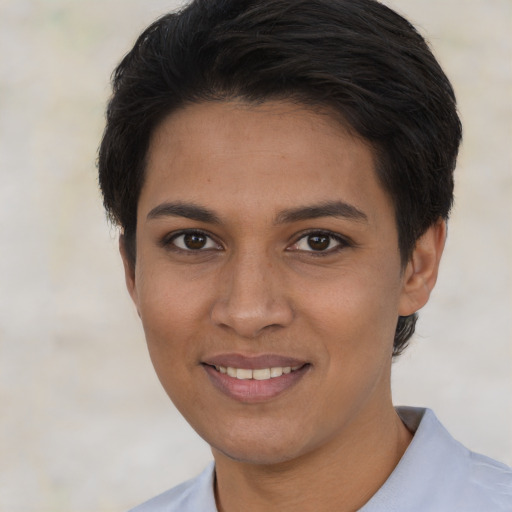 Joyful latino young-adult female with short  brown hair and brown eyes