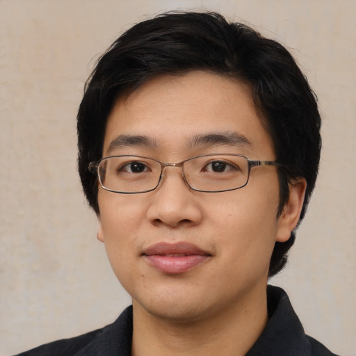 Joyful asian young-adult male with short  black hair and brown eyes