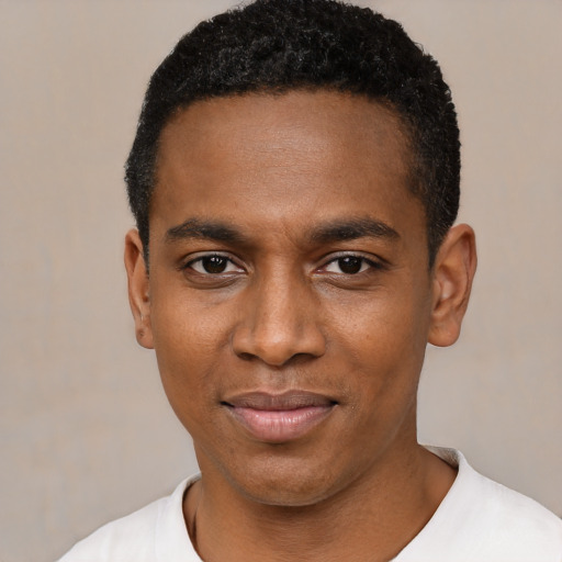 Joyful black young-adult male with short  black hair and brown eyes