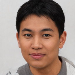 Joyful asian young-adult male with short  black hair and brown eyes