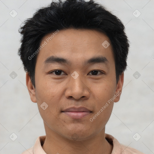 Joyful asian young-adult male with short  black hair and brown eyes