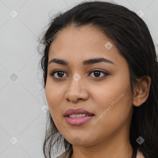 Joyful latino young-adult female with long  black hair and brown eyes