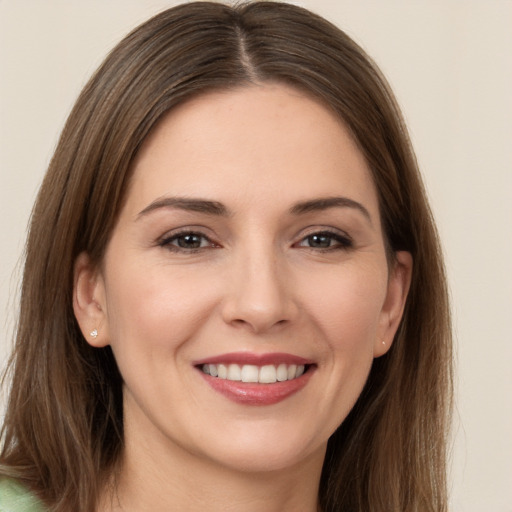 Joyful white young-adult female with long  brown hair and brown eyes