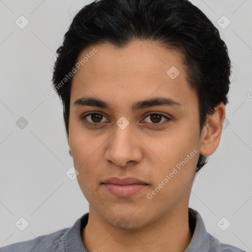 Joyful latino young-adult male with short  black hair and brown eyes