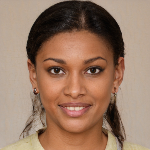 Joyful black young-adult female with short  brown hair and brown eyes