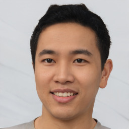 Joyful asian young-adult male with short  black hair and brown eyes