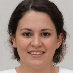 Joyful white adult female with medium  brown hair and brown eyes