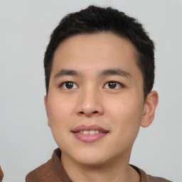 Joyful asian young-adult male with short  brown hair and brown eyes