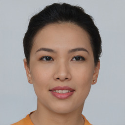 Joyful asian young-adult female with short  brown hair and brown eyes