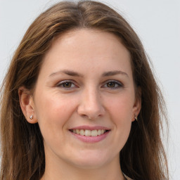 Joyful white young-adult female with long  brown hair and grey eyes