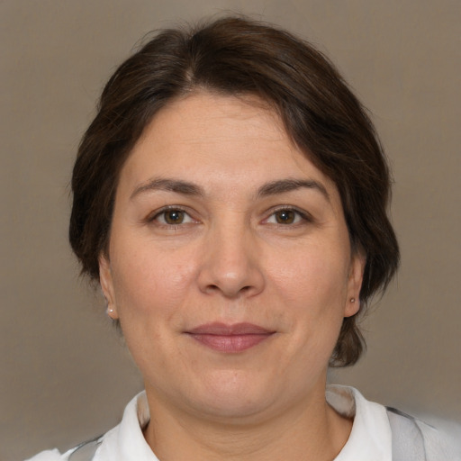 Joyful white adult female with medium  brown hair and brown eyes
