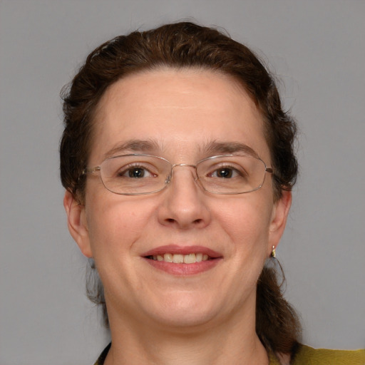 Joyful white adult female with medium  brown hair and blue eyes